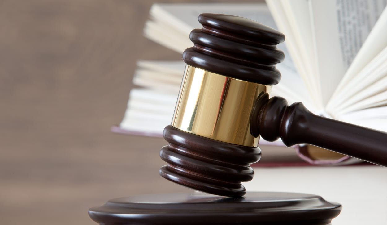 wooden gavel and books on wooden table