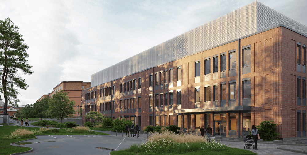 En stor tegelbyggnad som ligger vid sidan av en väg.